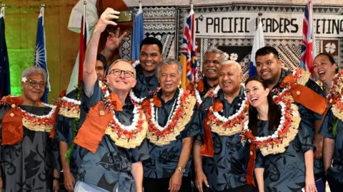 Getty Images Australia's Prime Minister Anthony Albanese (front) takes a selfie with fellow leaders during the Pacific Islands Forum (PIF)