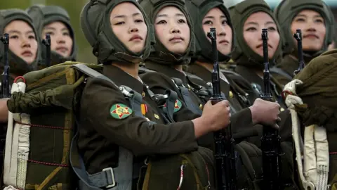 Reuters Female officers in a row holding guns