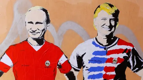 Reuters A mural signed by "TV Boy" and depicting Russian President Vladimir Putin and US President Donald Trump as soccer players