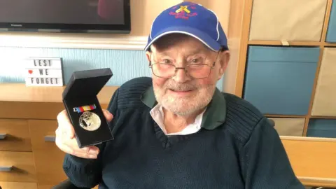 Phil Connell / BBC Picture of Mr Copeland with his medal
