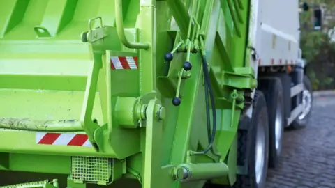 Getty Images Green recycling truck