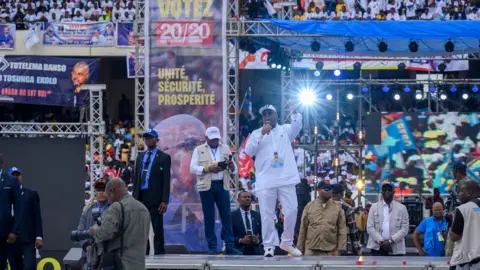 AFP Incumbent President of the Democratic Republic of the Congo and presidential candidate Felix Tshisekedi (C) of the Union for Democracy and Social Progress (UDPS) political party addresses his supporters at the Stade des Martyrs during his first campaign rally as the electoral campaign officially kicks off ahead of the 2023 general elections in Kinshasa on November 19, 2023.