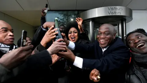 Reuters Relatives and friends of former Ivory Coast President Laurent Gbagbo celebrate outside the International Criminal Court