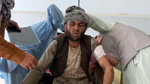 EPA A man who was injured in a suicide bomb attack that targeted an election campaign rally of incumbent president Ashraf Ghani, receives medical treatment at a hospital, on the outskirts of Kabul, Afghanistan