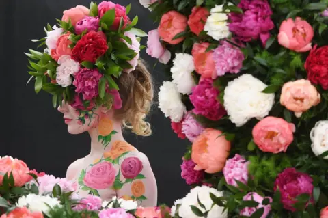 EPA A model poses at Chelsea Flower Show