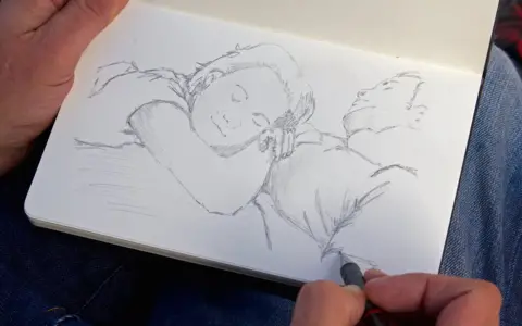 BBC Stephen O'Grady sketching in his pad