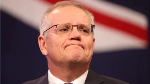 Getty Images Prime Minister of Australia Scott Morrison concedes defeat following the results of the Federal Election during the Liberal Party election night event at the Fullerton Hotel on May 21, 2022 in Sydney, Australia.