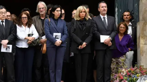 Getty Images French Culture Minister Rima Abdul-Malak (centre-left) and First Lady Brigitte Macron (centre-right) attend the funeral