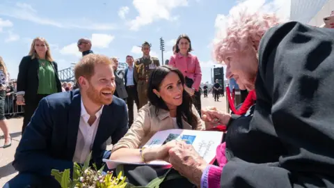 Getty Images Prince Harry, Meghan Markle and Daphne Dunne