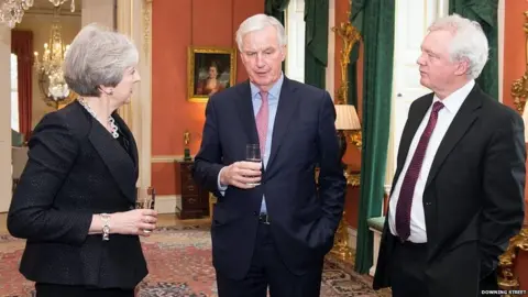 Downing Street David Davis (far right) with Theresa May and Michel Barnier in Downing Street in February