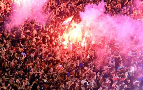 AFP/Getty Images Croatia supporters celebrate the second goal as they watch on a giant screen the Russia 2018 World Cup semi-final football match between Croatia and England, at the main square in Zagreb