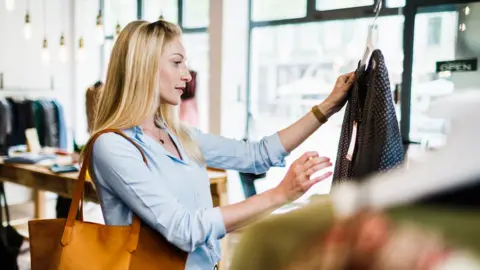 Getty Images Woman shopping for clothes