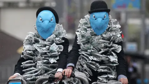 Getty Images Protestors dressed as eagles protest against Barclays' pay arrangements at the company's 2012 AGM