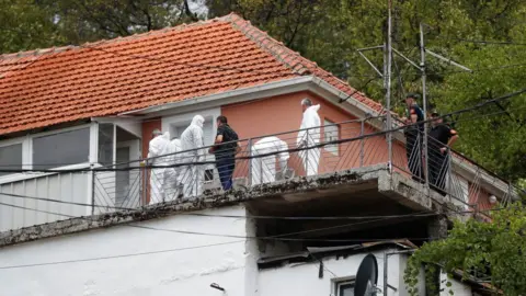 Reuters Image shows forensic team inspecting house