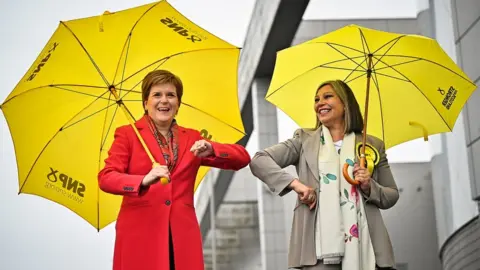 Getty Images SNP candidate Kaukab Stewart and Nicola Sturgeon elbow bump