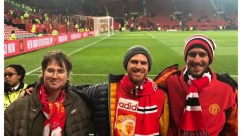 Yoni, in the middle, at Old Trafford with friends