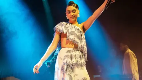 Getty Images Joy Crookes on stage at the O2