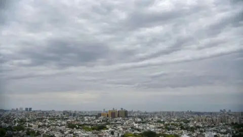 Getty Images A view of clear blue and white skies, clean air in the city during the nationwide lockdown to curb spread of coronavirus (Covid-19) at sector-30 near Delhi-Gurugram expressway on April 20, 2020 in Gurugram, India.