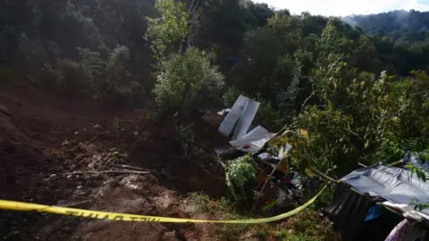 Reuters A police tape ropes off area where people died in mudslide