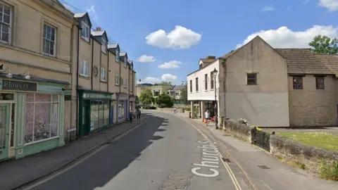Google Maps Castle Street in Clane when sunny, showing businesses down the left hand side