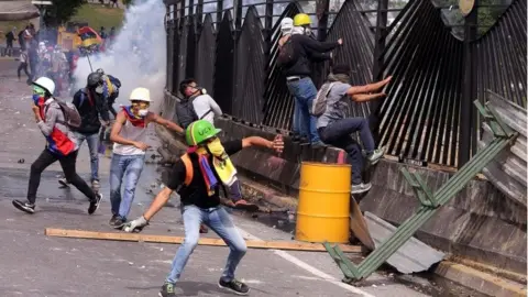 EPA 6 Protestors destroy the gate at the La Carlota airbase in Caracas, Venezuela, 31 May 2017