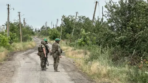 Joe Phua Ukrainian troops inspecting mined roads