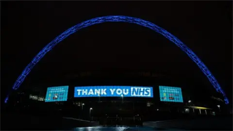 PA Media Wembley Stadium Arch in London lit up in blue