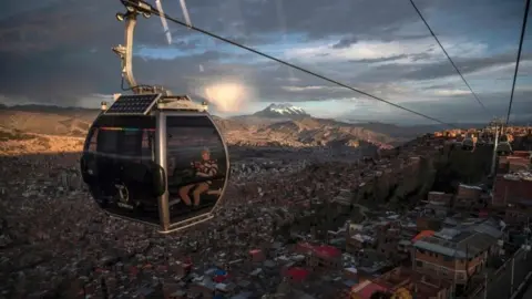 AFP View from a cable car of La Paz with the Illimani mountain in the background in El Alto, Bolivia