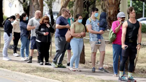 Getty Images People queue in Adelaide on Monday
