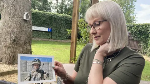 Sarah Adams holding a picture of her son