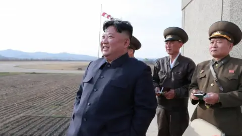 Reuters Kim Jong-un watches a flight training on April 16 with military personnel assisting him