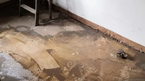 Sarah Brackstone Flood damage to Sarah Brackstone's floor