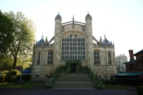 Danny Lawson/PA Flowers and foliage surround the West Door and steps of St George's Chapel at Windsor Castle for the wedding of Prince Harry to Meghan Markle