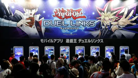 Getty Images Visitors play Yu-Gi-Oh! Duel Links video game in the Konami Holdings Corp. booth at Tokyo Game Show on September 17, 2016