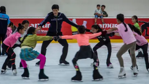 Omar Havana Sen Bunthoeurn with a group of children on the ice