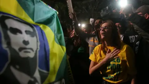 Reuters Supporters of Jair Bolsonaro, far-right lawmaker and presidential candidate of the Social Liberal Party (PSL), react after Bolsonaro wins the presidential race, in Sao Paulo, Brazil