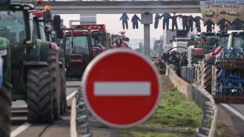 REUTERS/Nacho Doce French farmers block the A64 highway with their tractors to protest over price pressures, taxes and green regulation, grievances shared by farmers across Europe, in Carbonne, south of Toulouse