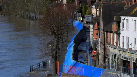 Reuters Temporary flood protection barriers are seen in place beside the swollen River Severn at Ironbridge