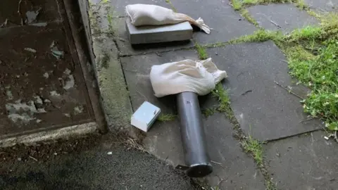 PSNI An explosive device lies on the ground nest to a public bus stop.