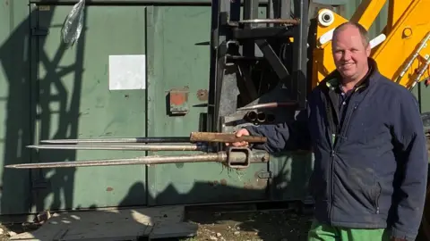 EAAA Jonathan Willis holding forklift tine