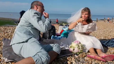 Getty Images Newlyweds pictured on a beach