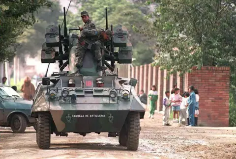 Getty Images Colombian soldiers patrol the vicinity of the La Picota prison in Bogota, where Cali drug cartel boss Gilberto Rodriguez Orejuela was being held in 1995