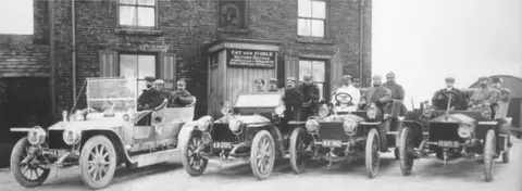 Forest Distillery Gathering of motor cars outside Cat & Fiddle in June 1907