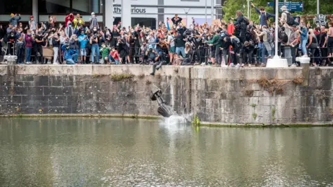 Reuters The statue of Edward Colston falls into the water after protesters pulled it down and pushed into the docks,