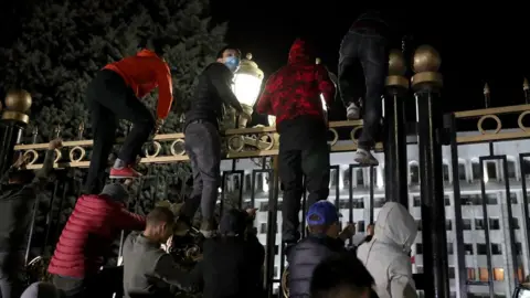 EPA Opposition protesters against the parliamentary election results storm the gates of the Government House in central Bishkek, Kyrgyzstan, 5 October 2020