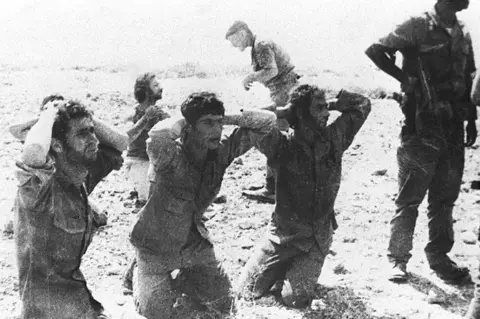 Getty Images Greek Cypriot soldiers surrender to invading Turkish forces, 1974