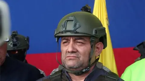 Reuters Colombian drug trafficker Dairo Antonio Usuga David, also known as "Otoniel", is pictured as he gets escorted by police officers after Colombia extradites him to the United States, in Bogota, Colombia May 4, 2022.