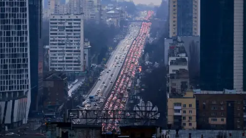 Getty Images Cars blocking the road out of Kyiv