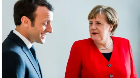 AFP Emmanuel Macron and Angela Merkel