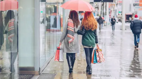 Getty Images Shoppers in the rain